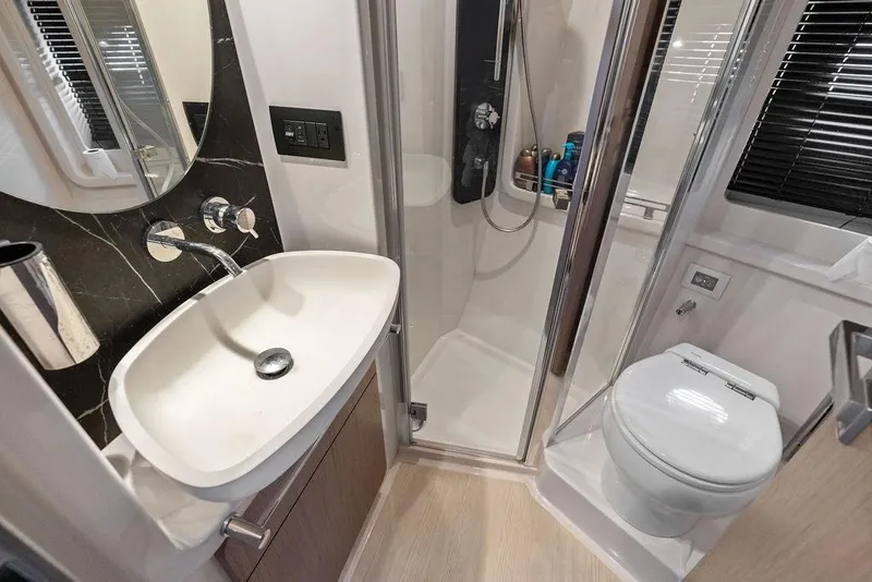 Slide: The Image of Luxurious bathroom in 2022 Azimut Fly 50 yacht, featuring modern sink, shower, and toilet. - 49