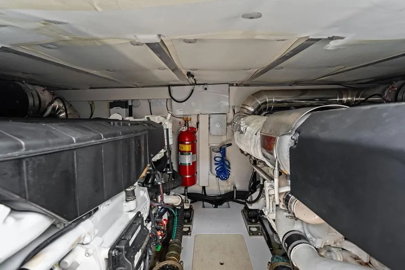 Slide: The Image of Engine room of 2022 Azimut Fly 50 yacht, featuring dual engines and fire extinguisher. - 56
