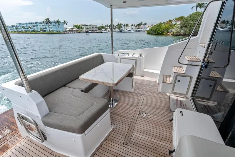Slide: The Image of Azimut Fly 50 yacht deck, 2022 model, featuring elegant seating and scenic waterfront view. - 18