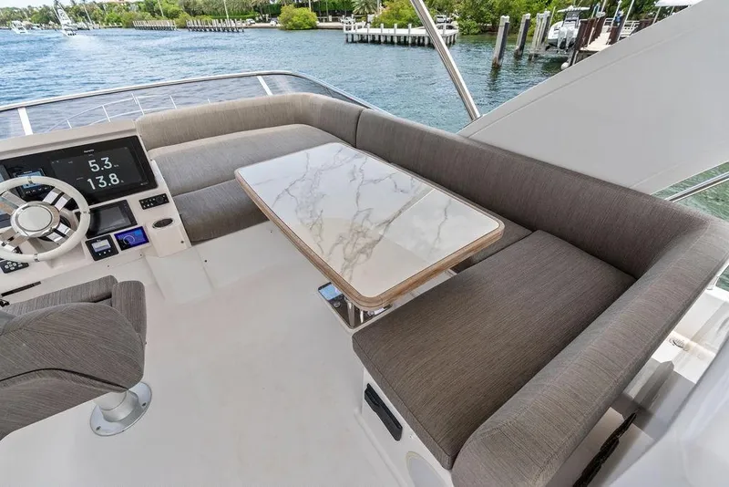 Slide: The Image of Luxurious seating area on 2022 Azimut Fly 50 yacht with marble table and helm controls. - 23