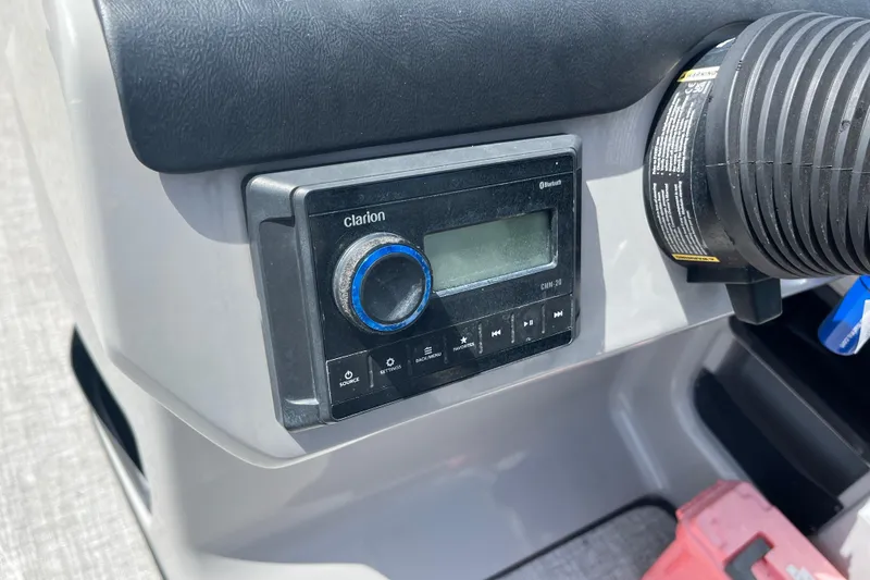 Slide: The Image of 2024 Harris Cruiser 230 dashboard featuring a Clarion audio system with Bluetooth connectivity. - 12