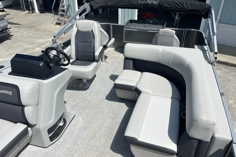 Slide: The Image of 2024 Harris Cruiser 230 pontoon boat interior with plush seating and modern helm. - 9