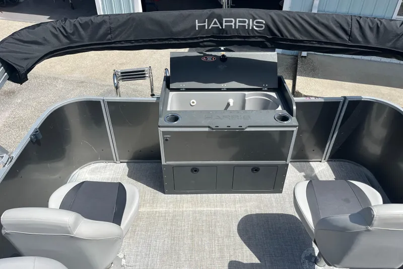 Slide: The Image of 2024 Harris Cruiser 230 boat interior with seating and a built-in sink. - 14
