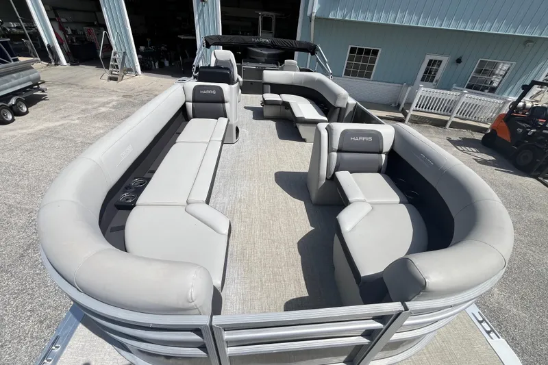 Slide: The Image of 2024 Harris Cruiser 230 pontoon boat with spacious seating and modern design. - 8