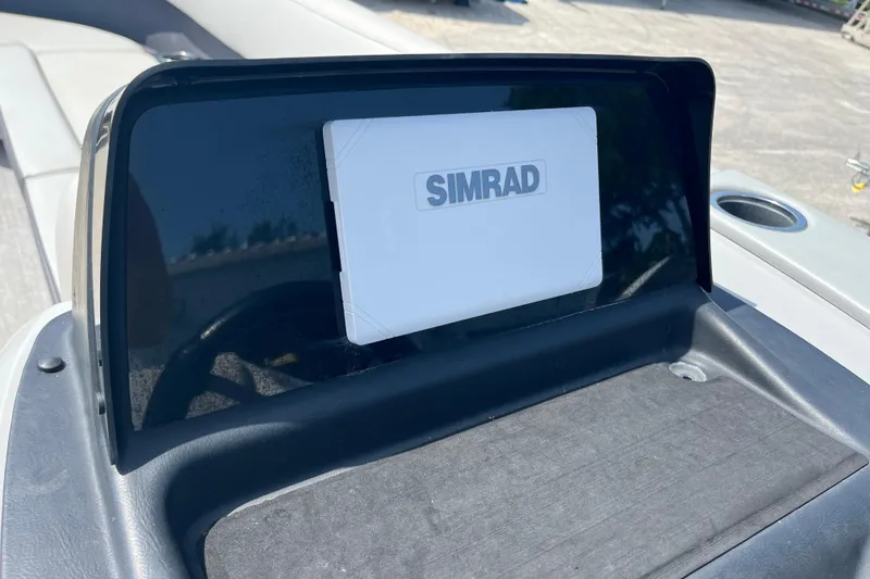 Slide: The Image of 2024 Harris Cruiser 230 dashboard featuring a Simrad navigation system. - 13