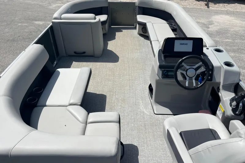 Slide: The Image of 2024 Harris Cruiser 230 pontoon boat interior with modern seating and steering console. - 16