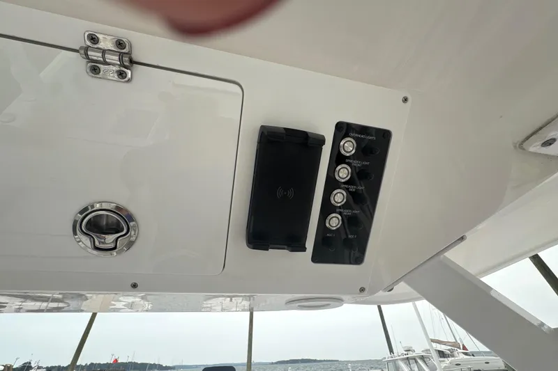 Slide: The Image of Control panel on 2023 Sea Fox 268 Traveler boat, featuring switches and a wireless charging pad. - 39
