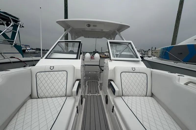 Slide: The Image of 2023 Sea Fox 268 Traveler boat interior with white quilted seating and open deck. - 9