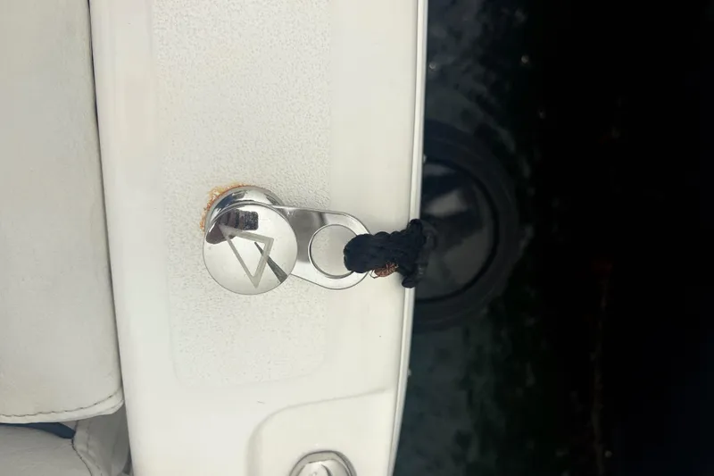 Slide: The Image of Close-up of a 2023 Sea Fox 268 Traveler boat cleat with a black rope. - 53