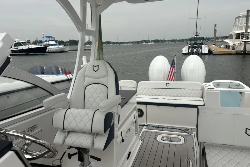 Slide: The Image of 2023 Sea Fox 268 Traveler boat interior with luxury seating and dual engines at a marina. - 26