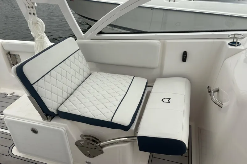 Slide: The Image of 2023 Sea Fox 268 Traveler boat seat with white quilted upholstery and blue trim. - 32
