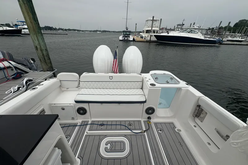 Slide: The Image of 2023 Sea Fox 268 Traveler boat interior at marina, featuring seating and storage. - 15