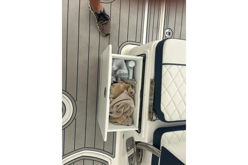 Slide: The Image of 2023 Sea Fox 268 Traveler boat interior with open storage compartment and towels. - 55