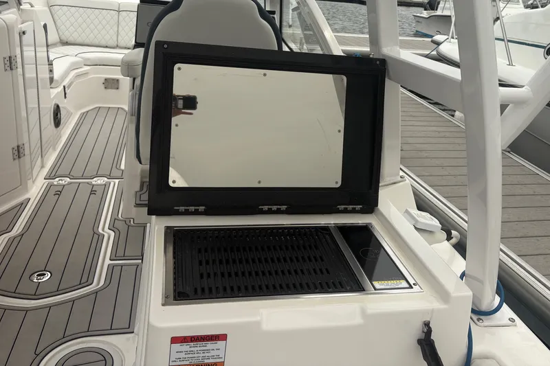 Slide: The Image of 2023 Sea Fox 268 Traveler boat interior with grill and seating area. - 44