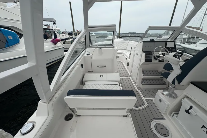 Slide: The Image of 2023 Sea Fox 268 Traveler boat interior with seating and steering console at a marina. - 31