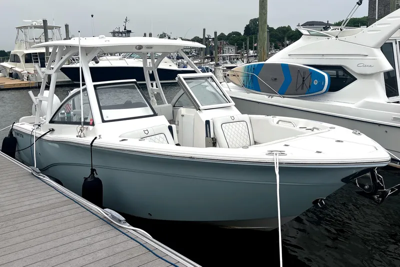 Slide: The Image of 2023 Sea Fox 268 Traveler boat docked at marina, featuring sleek design and spacious seating. - 1