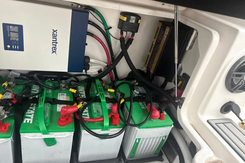 Slide: The Image of Electrical system setup in a 2023 Sea Fox 268 Traveler boat, featuring batteries and wiring. - 47