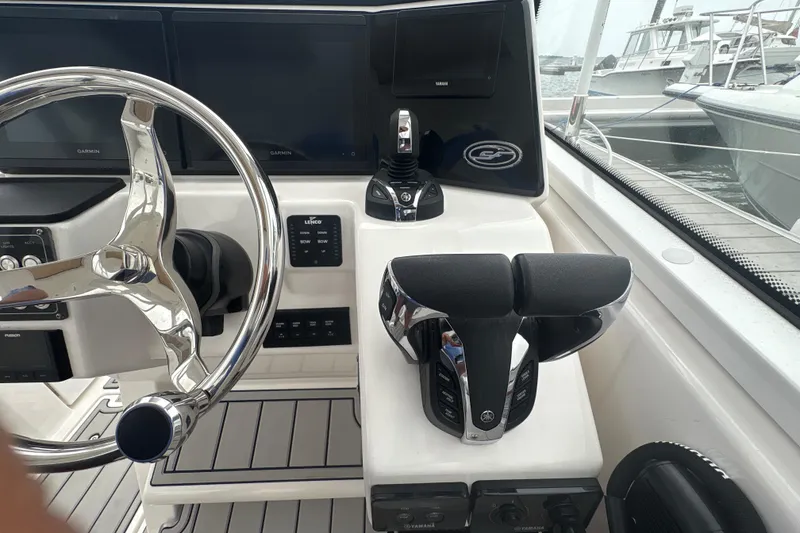Slide: The Image of 2023 Sea Fox 268 Traveler boat cockpit with steering wheel and controls. - 21