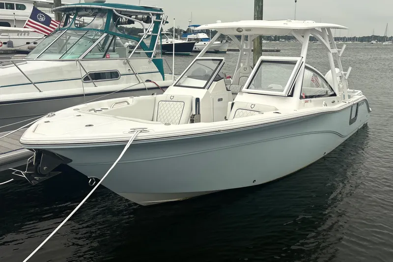 The Image of 2023 Sea Fox 268 Traveler boat docked in a marina, showcasing sleek design and spacious seating. - 0