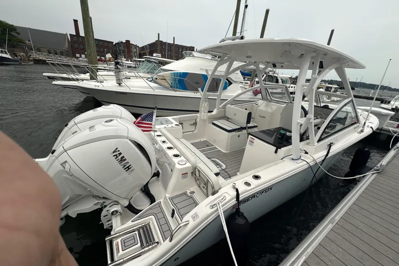 Slide: The Image of 2023 Sea Fox 268 Traveler boat docked, featuring Yamaha engines and spacious seating. - 13