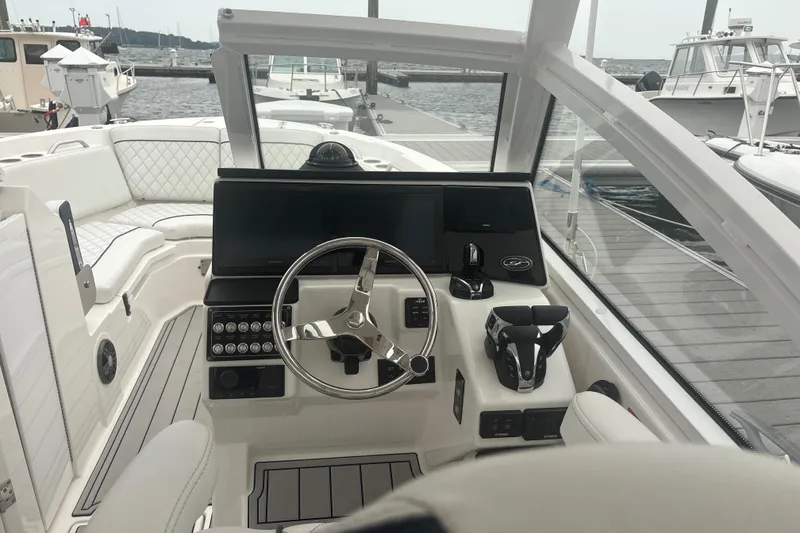 Slide: The Image of 2023 Sea Fox 268 Traveler boat cockpit with modern steering and controls at marina. - 19