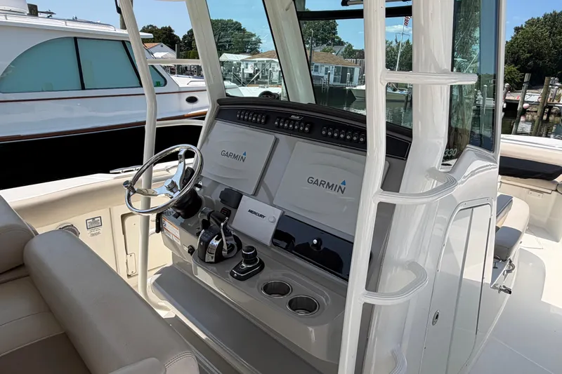 Slide: The Image of 2017 Boston Whaler 330 Outrage helm with Garmin navigation system and Mercury controls. - 14