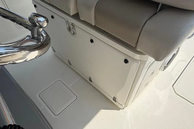 Slide: The Image of 2017 Boston Whaler 330 Outrage boat interior with storage compartment and seating. - 28