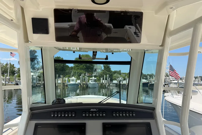 Slide: The Image of Interior view of a 2017 Boston Whaler 330 Outrage boat at a marina. - 36