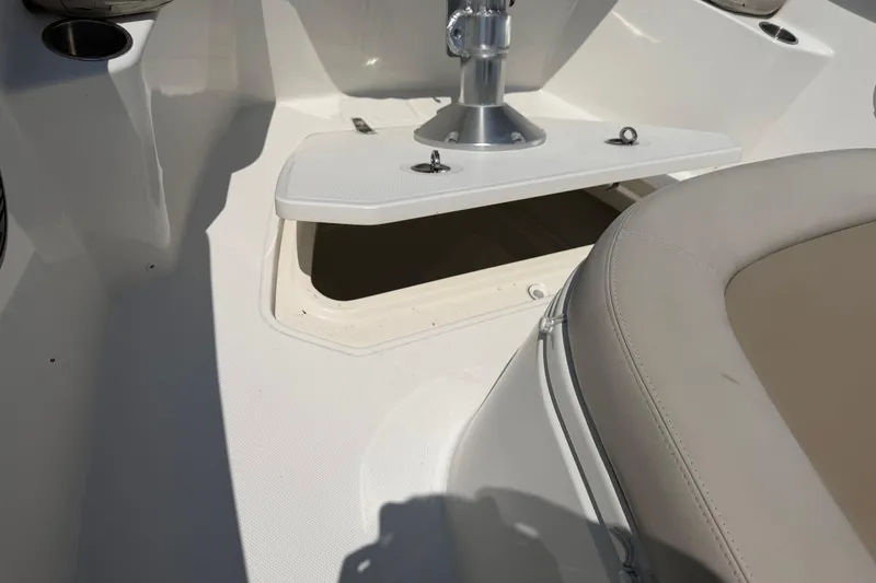 Slide: The Image of 2017 Boston Whaler 330 Outrage boat interior with open storage compartment and seating. - 45