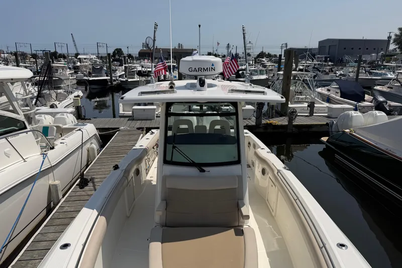 Slide: The Image of 2017 Boston Whaler 330 Outrage docked at marina with Garmin equipment. - 42