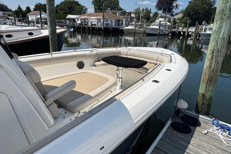 Slide: The Image of 2017 Boston Whaler 330 Outrage docked, showcasing spacious seating and sleek design. - 9
