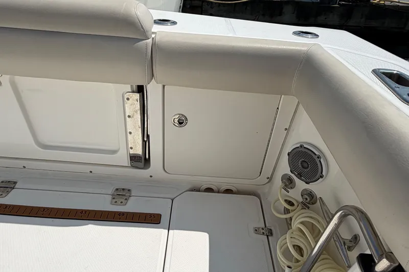 Slide: The Image of 2017 Boston Whaler 330 Outrage boat interior with storage compartment and speaker. - 20