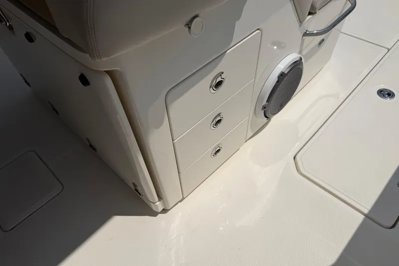 Slide: The Image of 2017 Boston Whaler 330 Outrage interior with storage drawers and speaker. - 30