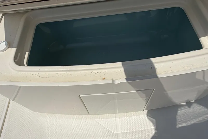 Slide: The Image of Livewell on a 2017 Boston Whaler 330 Outrage boat, featuring a clean, spacious design. - 23