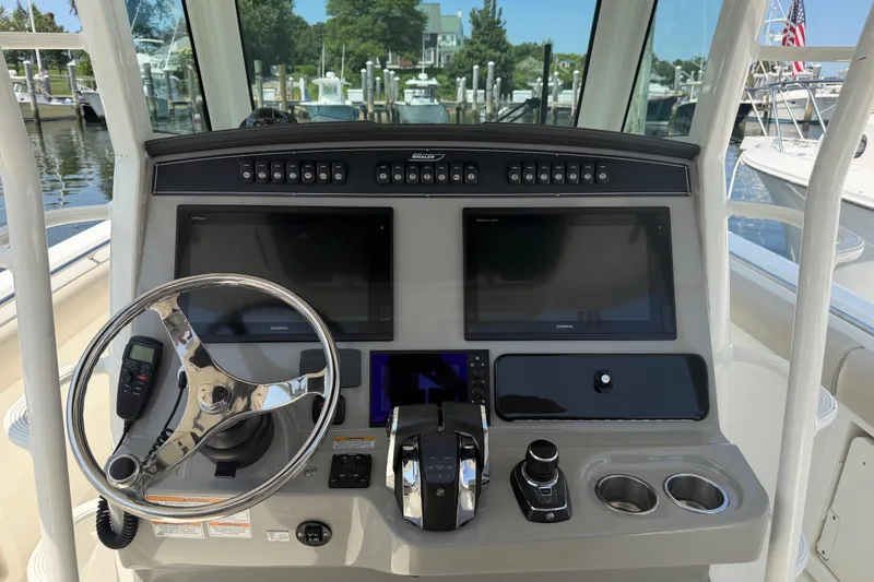 Slide: The Image of 2017 Boston Whaler 330 Outrage helm with dual Garmin displays and steering wheel. - 35