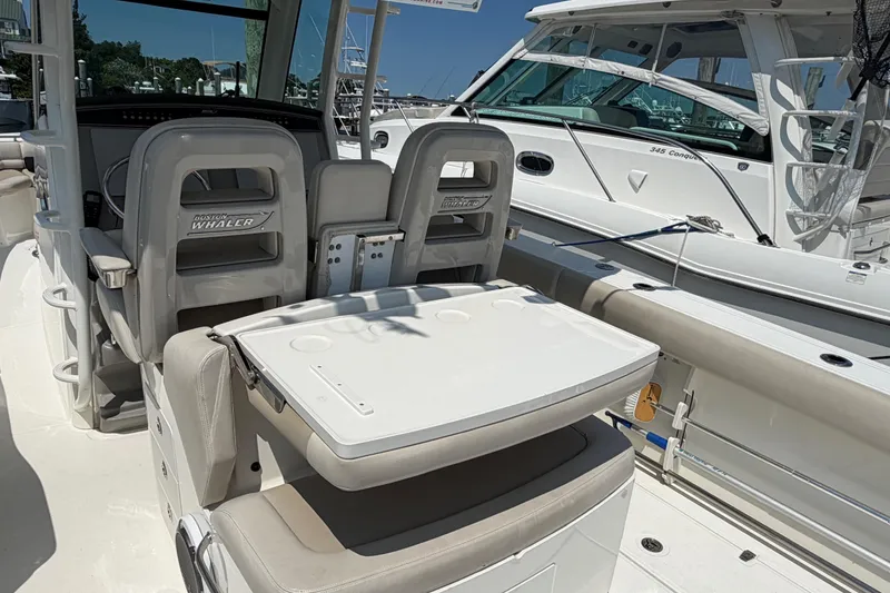 Slide: The Image of 2017 Boston Whaler 330 Outrage boat interior with seating and console details. - 24