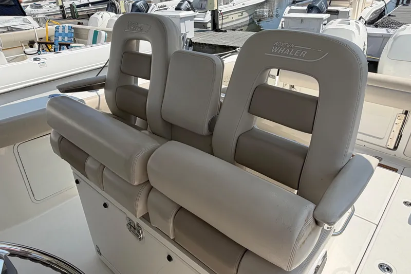Slide: The Image of 2017 Boston Whaler 330 Outrage boat seats, featuring comfortable gray upholstery. - 26