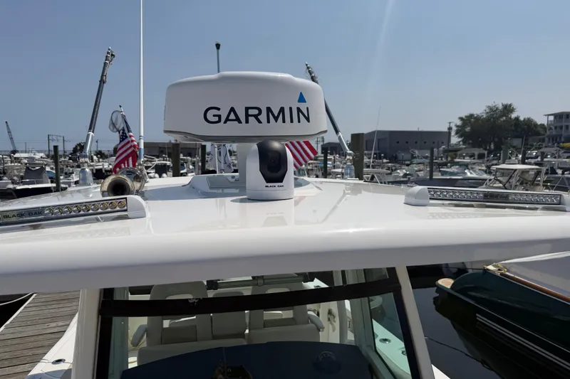 Slide: The Image of 2017 Boston Whaler 330 Outrage with Garmin radar, docked at a marina. - 48