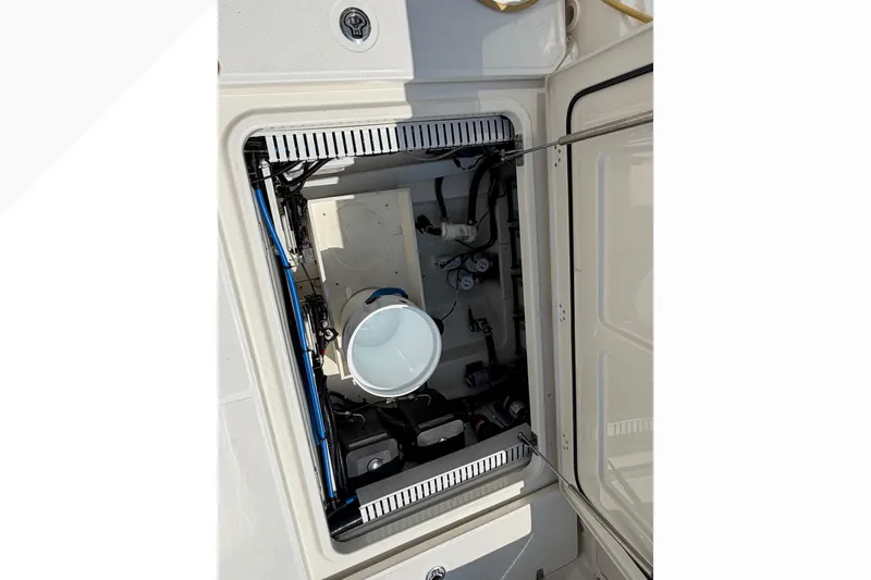 Slide: The Image of 2017 Boston Whaler 330 Outrage boat compartment with visible wiring and equipment. - 18