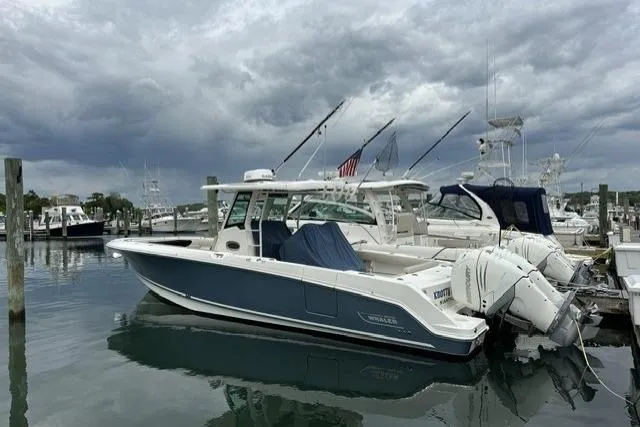 The Image of 2017 Boston Whaler 330 Outrage boat docked at marina under cloudy skies. - 0