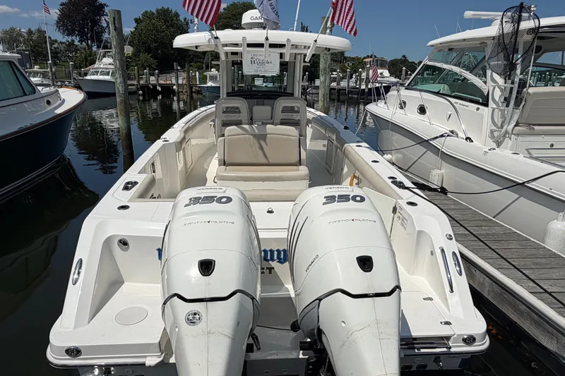 Slide: The Image of 2017 Boston Whaler 330 Outrage boat docked with twin 350 engines, marina background. - 3