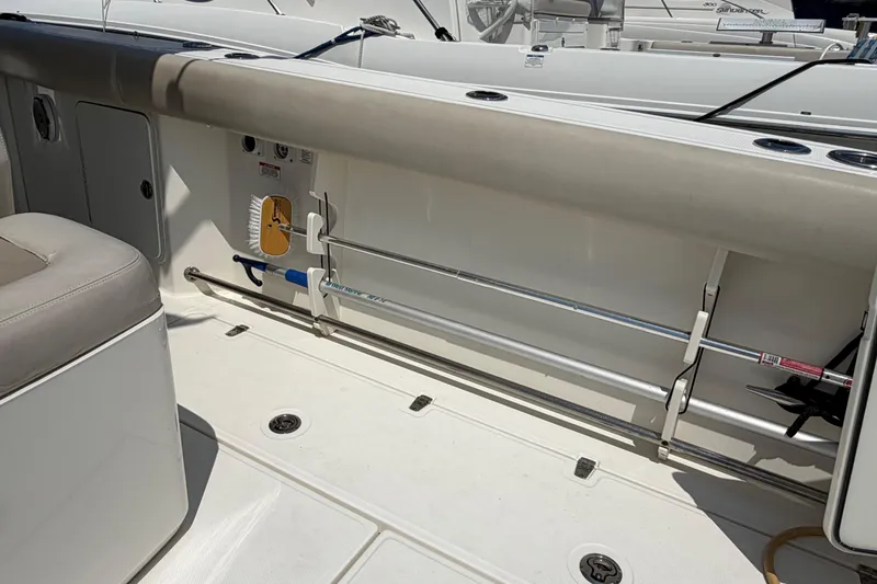 Slide: The Image of 2017 Boston Whaler 330 Outrage interior with storage and seating area. - 21