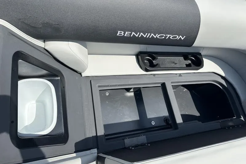Slide: The Image of Interior of 2026 Bennington S Quad Bench 20 SSR with storage compartments and cup holders. - 10