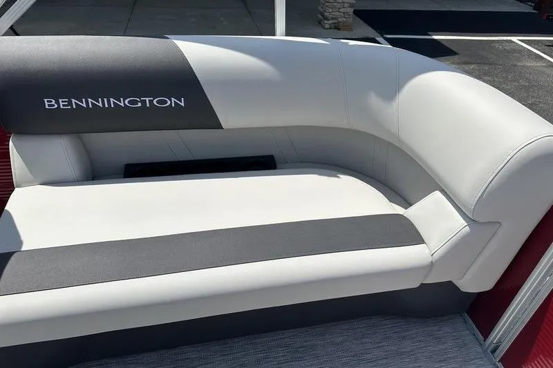 Slide: The Image of 2026 Bennington S Quad Bench 20 SSR boat seat, featuring sleek white and gray upholstery. - 17