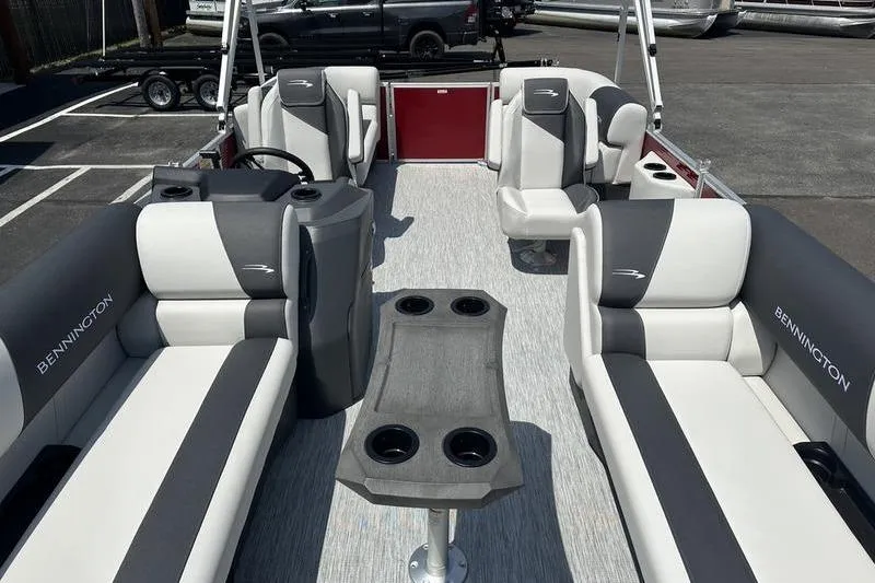 Slide: The Image of 2026 Bennington S Quad Bench 20 SSR pontoon boat interior with stylish seating and table. - 8