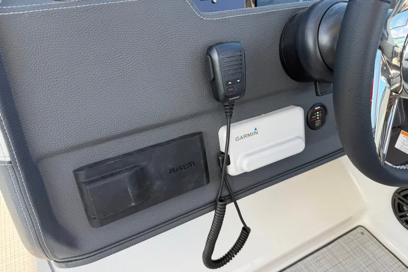 Slide: The Image of 2027 Regal 3300 boat dashboard with Garmin and Fusion audio controls. - 28