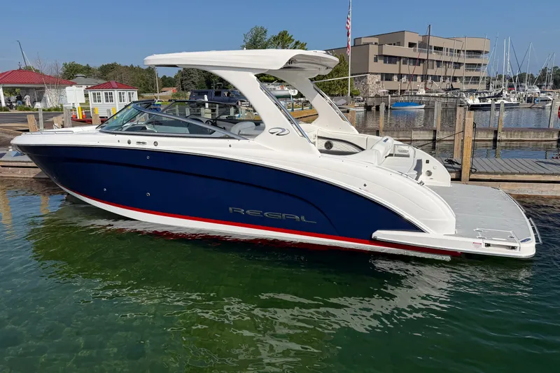Slide: The Image of 2027 Regal 3300 boat docked in marina, featuring sleek design and modern amenities. - 2