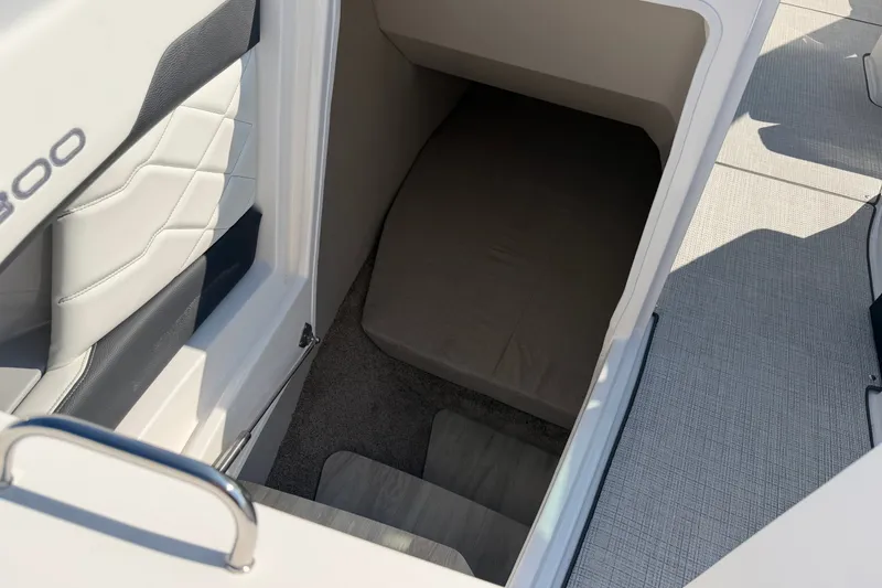 Slide: The Image of Interior cabin view of a 2027 Regal 3300 boat, featuring seating and steps. - 25