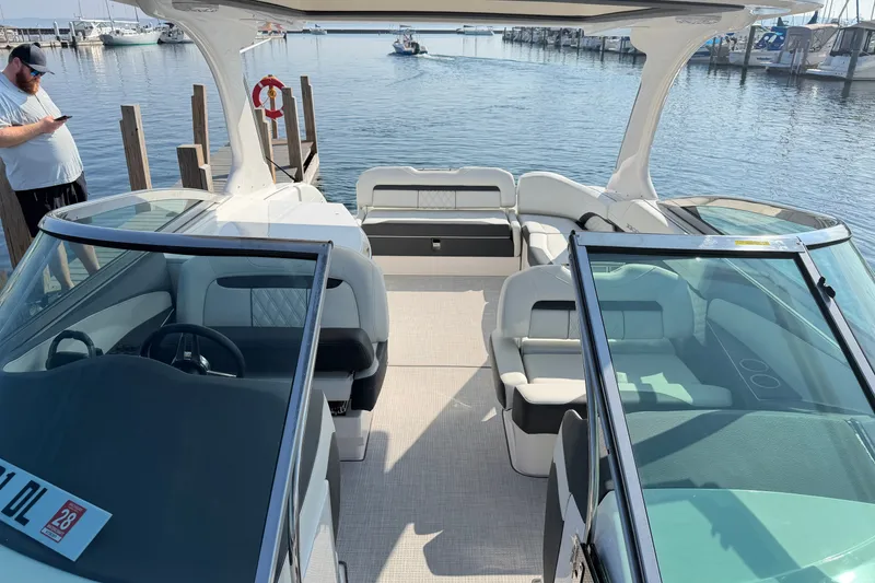 Slide: The Image of 2027 Regal 3300 boat interior at dock, featuring spacious seating and modern design. - 6