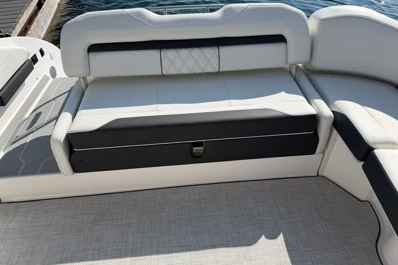 Slide: The Image of 2027 Regal 3300 boat interior with luxurious white and black seating by the water. - 23